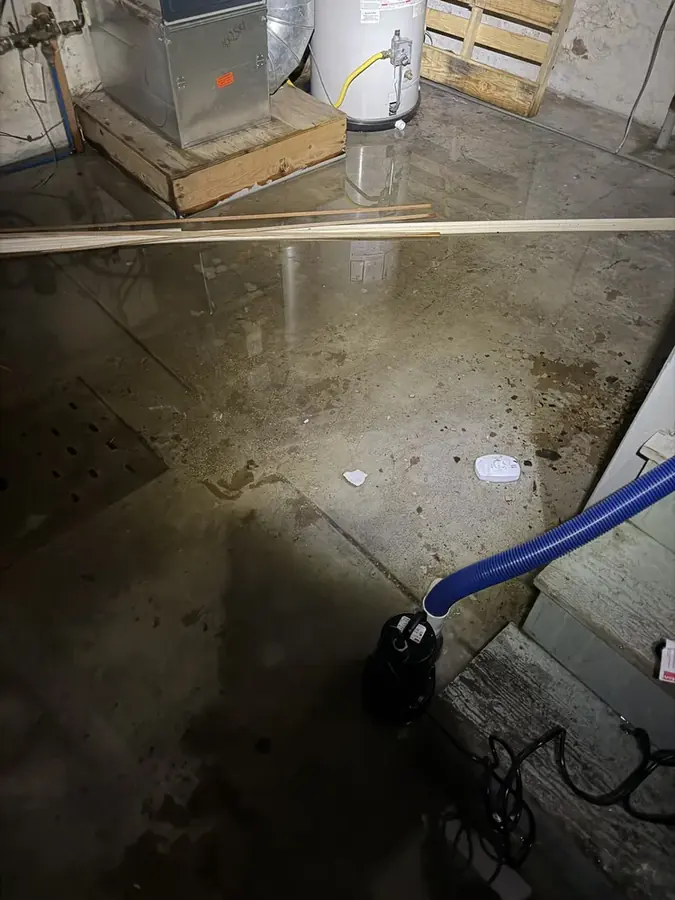 A corroded pipe leak traced at the wall base