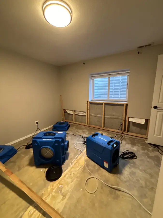 Air movers drying a room after a leak