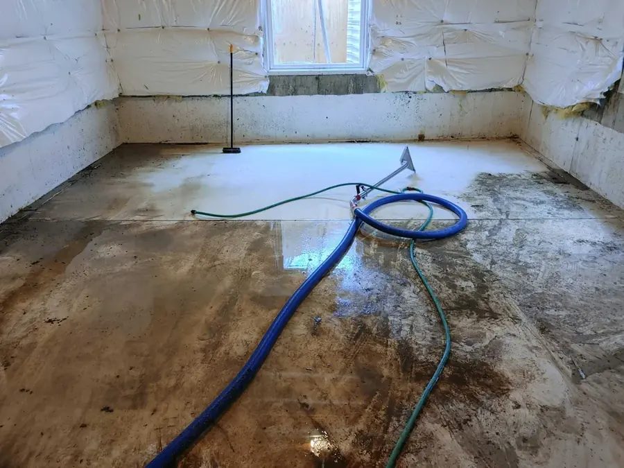 Axis Water Restoration technician drying a flooded Coppell, TX home with air movers