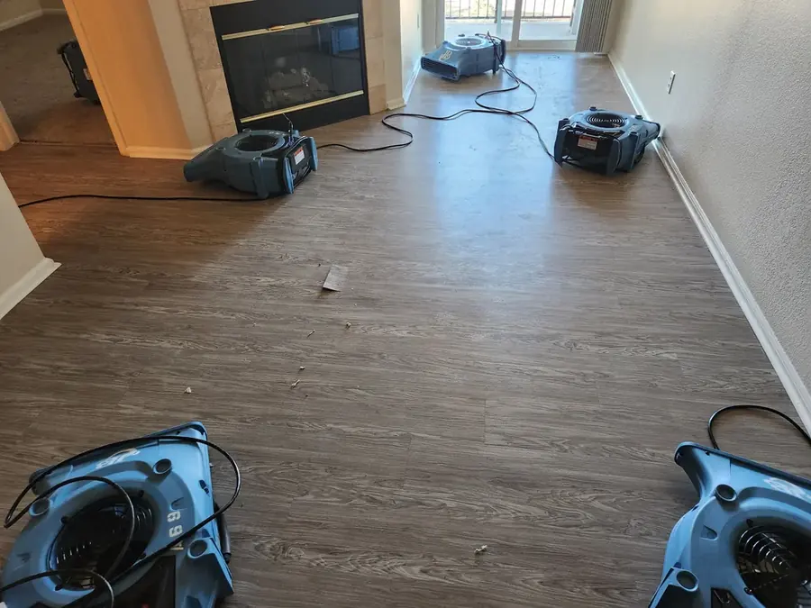 Axis Water Restoration technician removing wet drywall in a Coppell, TX home